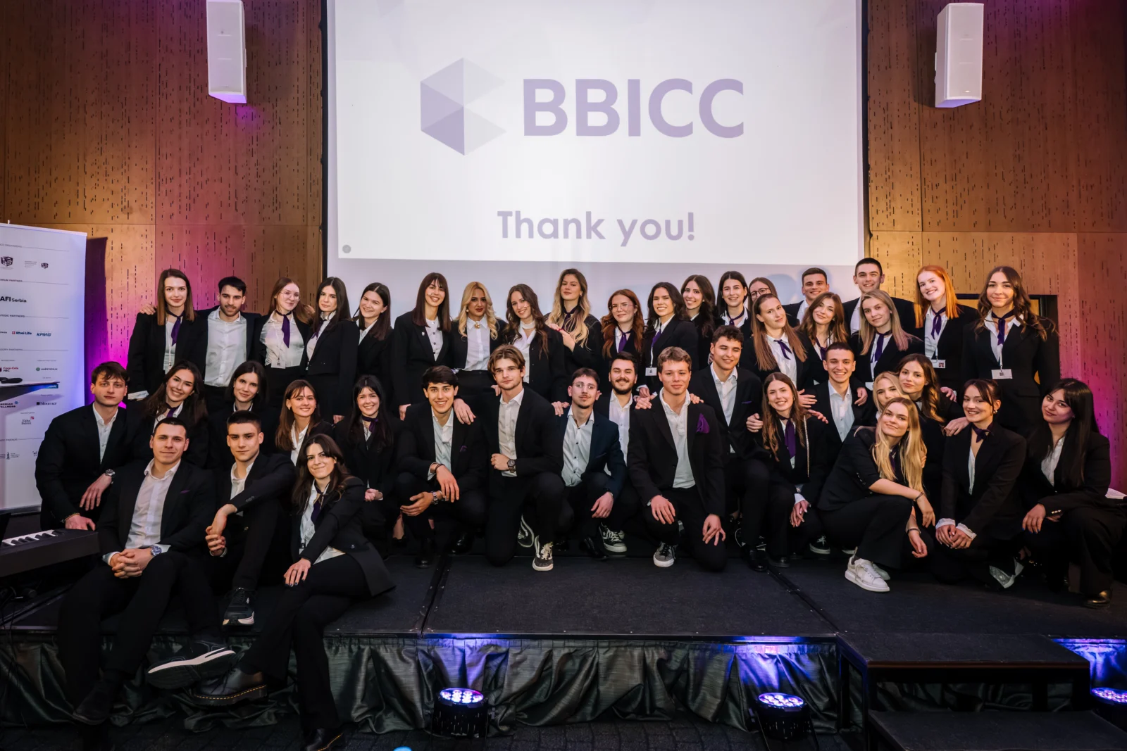 The BBICC organizing team posing on stage in front of the BBICC Thank you screen